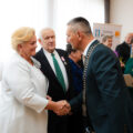 Na zdjęciu wójt składający gratulacje jubilatom poprzez uścisk dłoni.