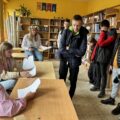 Zdjęcie przedstawia uczniów z zespołu szkół w Przemęcie oraz zaproszonych uczniów z pobliskich szkół. Wszyscy znajdują się w szkolnej bibliotece, gdzie odbywa się quiz przygotowany przez gospodarzy.