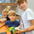 Chłopcy pozują do zdjęcia z konstrukcją lego.