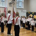 Na zdjęciu widoczny szkolny poczet sztandarowy, który stoi ustawiony w stronę pierwszoklasistów.